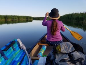 Woman paddling in a canoe