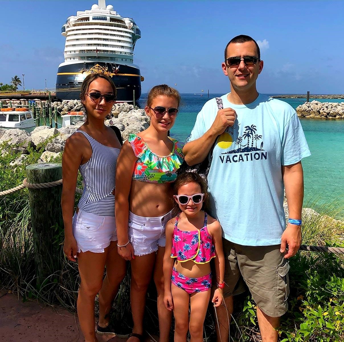Mike and his family standing on the cruise boat